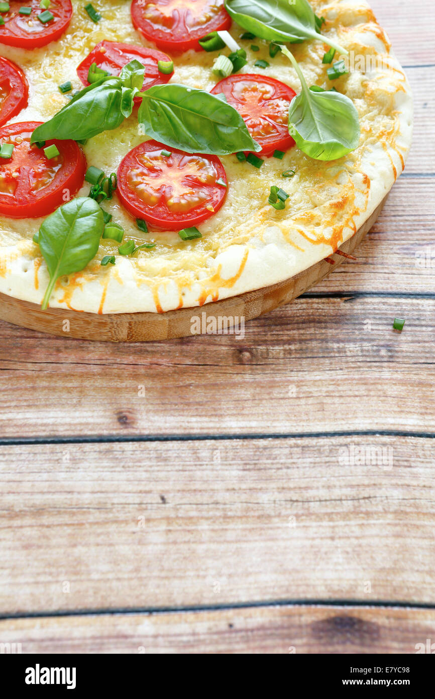 Tasty pizza with tomato, side view Stock Photo