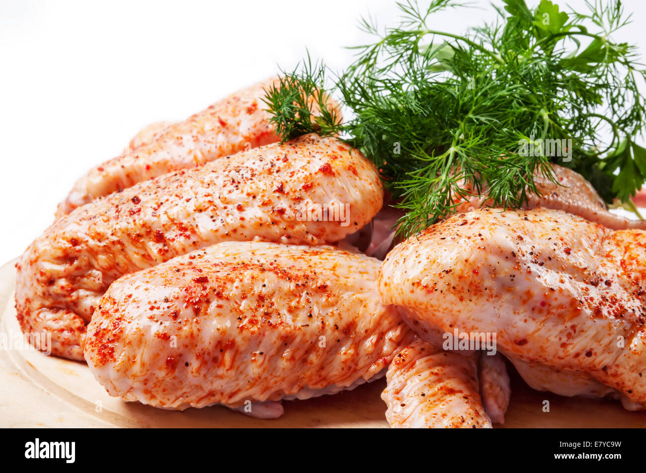 Spicy raw chicken wings  with green dill Stock Photo