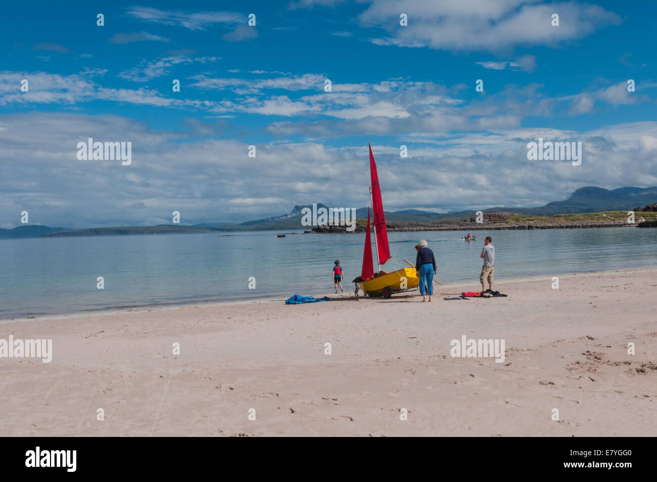 Yacht with red sails on beach Mellon Udrigle Gruinard Bay by Laide Ross & Cromarty Highland Scotland Stock Photo