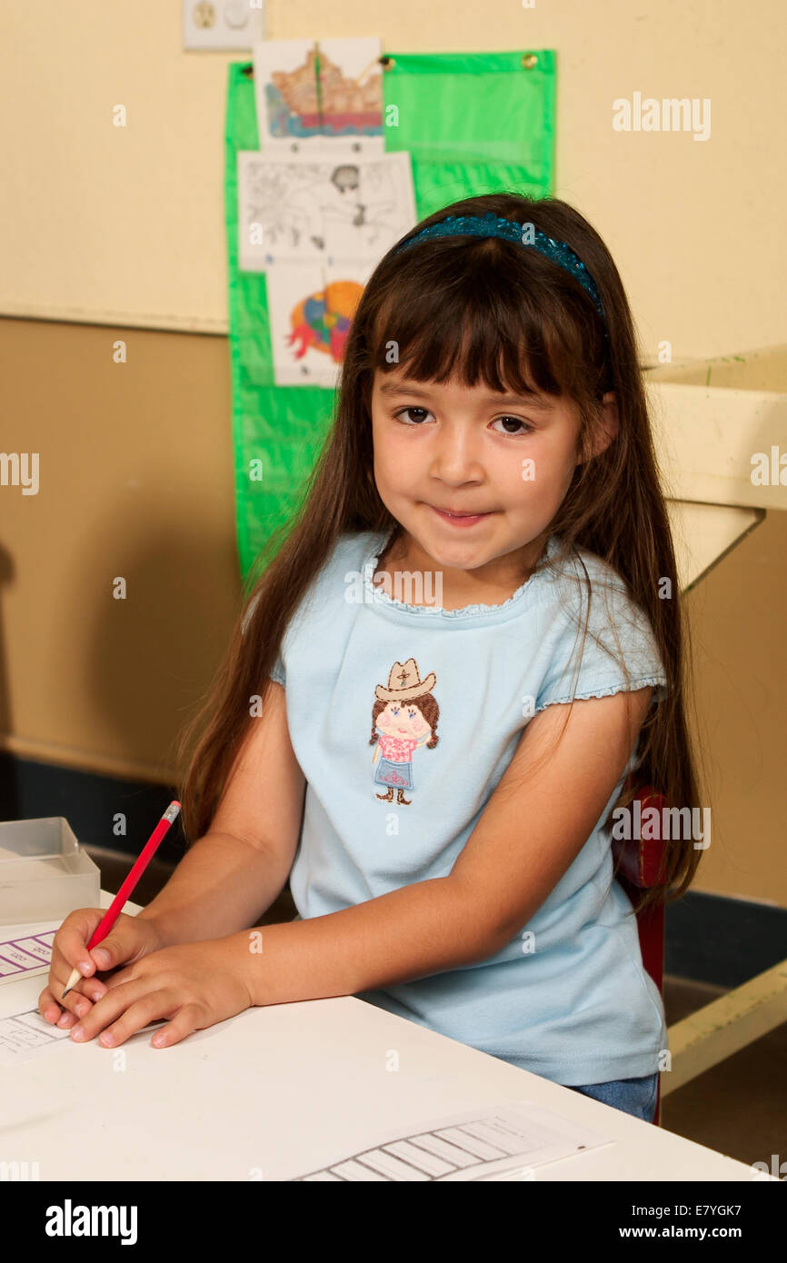 Relaxed 4-6 year old students student girls ethnic diversity mix diverse multicultural Hispanic girl iclassroom Looking at camera eye contact  MR Myrleen Pearson Stock Photo