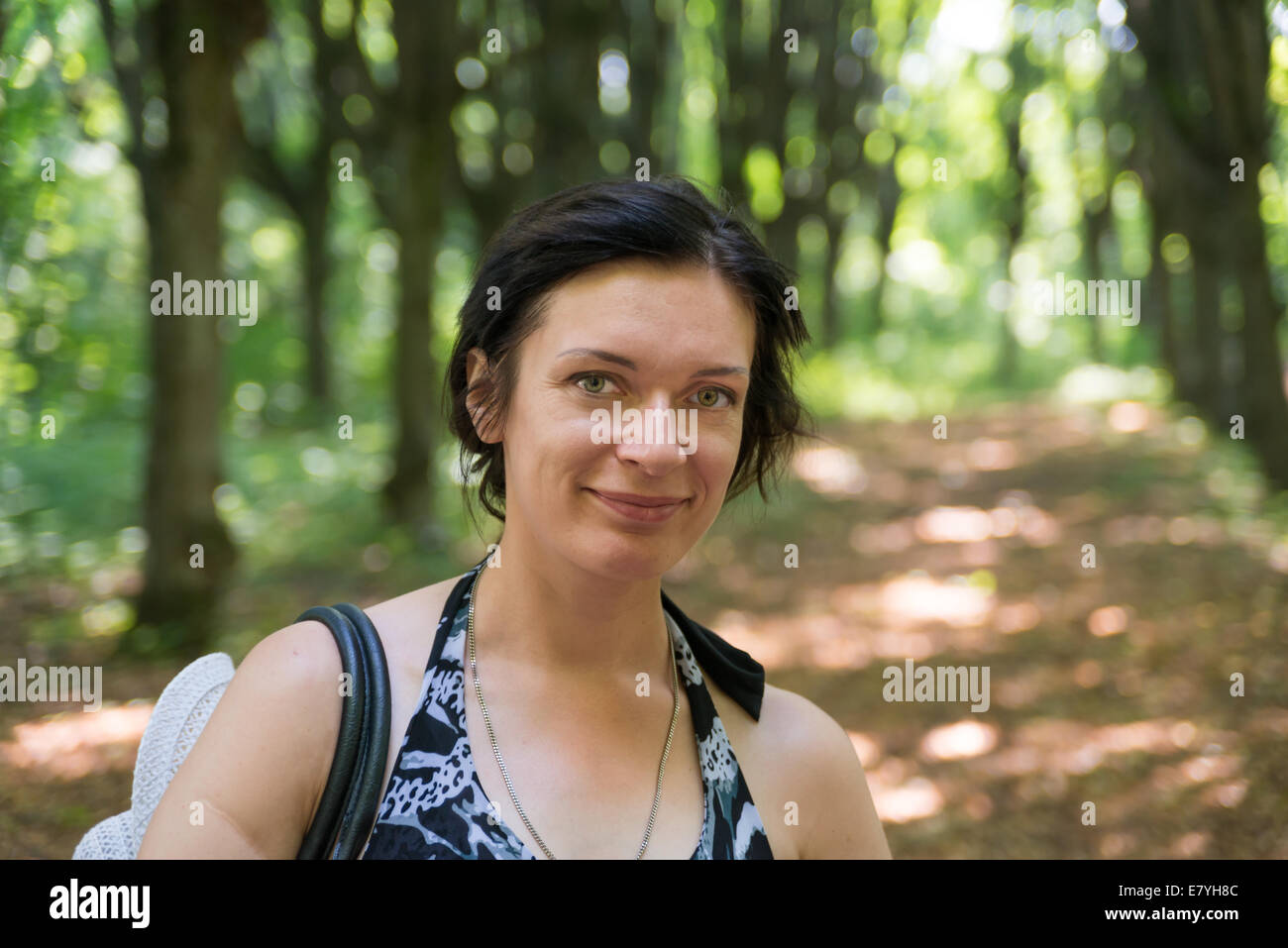 nice girl in a forest smiling Stock Photo