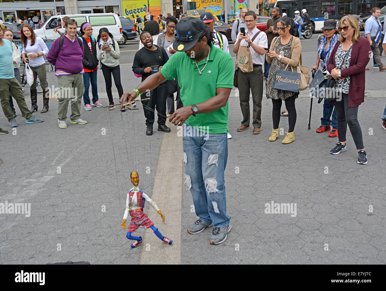 A marionette puppeteer with his dancing puppet in Union Square Park in Manhattan, new York City Stock Photo