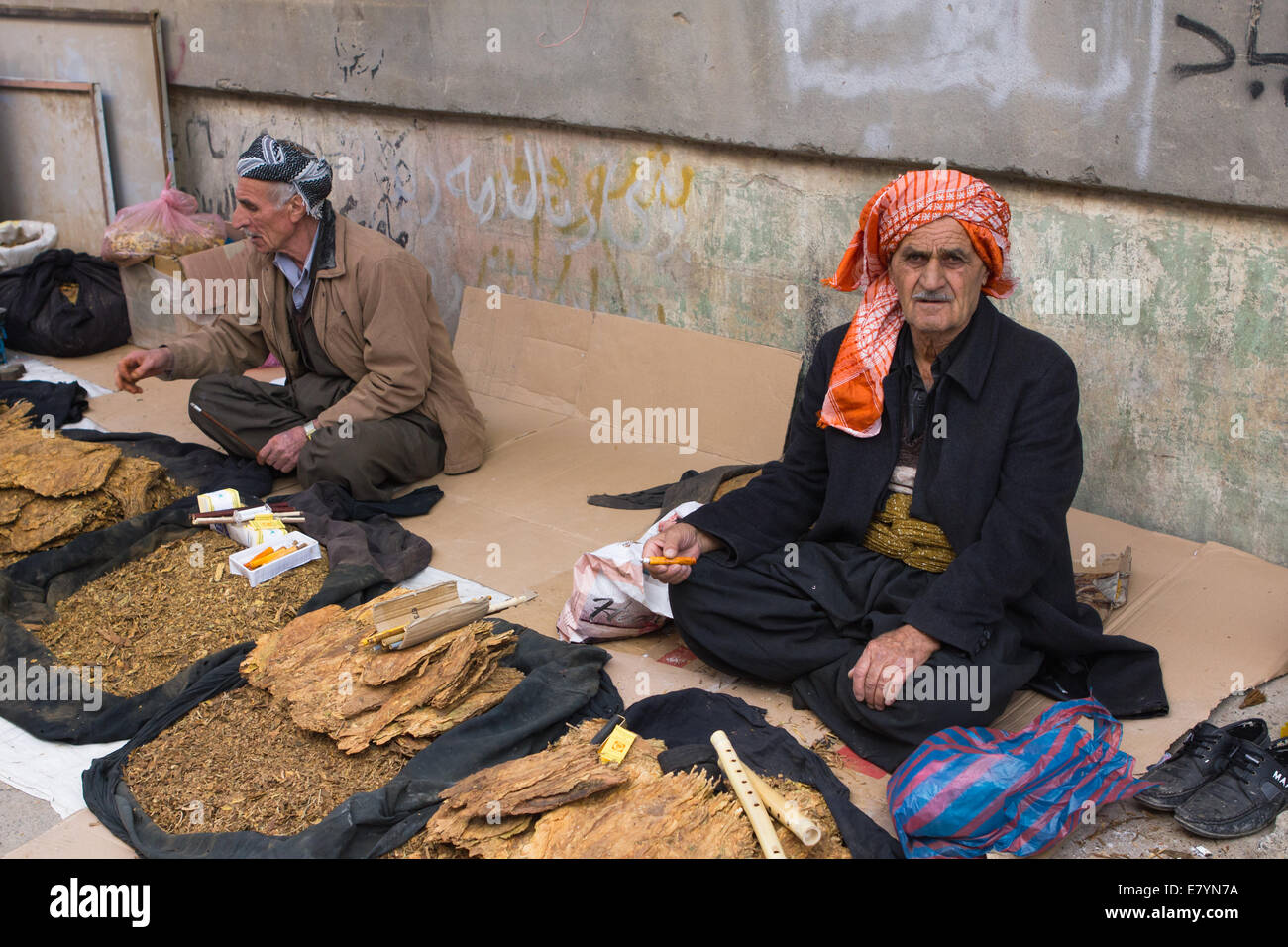 Kurdish street vendors wearing traditional clothing selling tobacco in Erbil (Arbil), Iraqi Kurdistan province, Iraq. Stock Photo