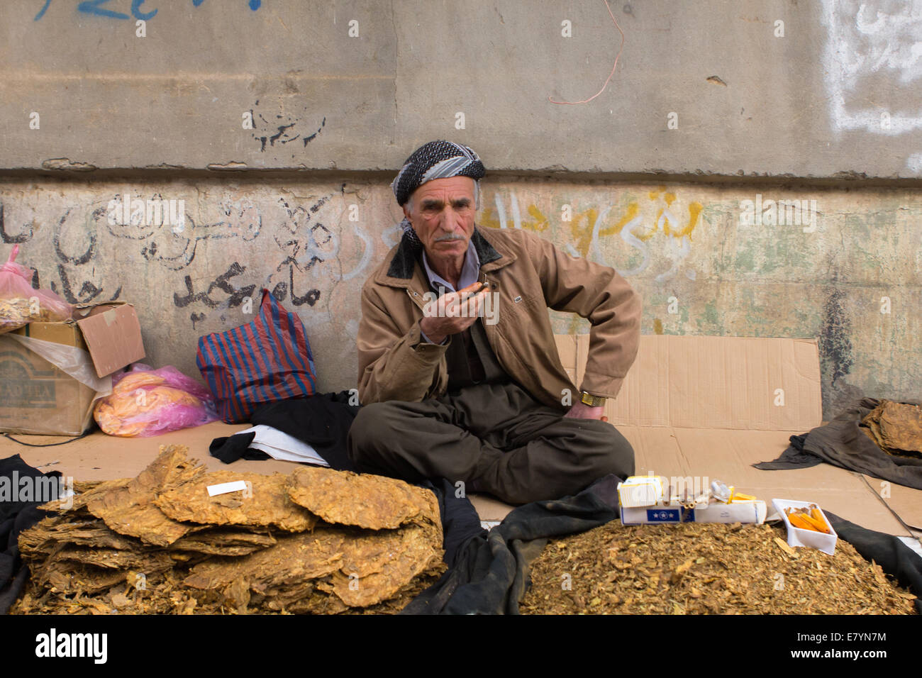 A Kurdish street vendor, wearing traditional clothing, selling tobacco in Erbil (Arbil), Iraqi Kurdistan province, Iraq. Stock Photo