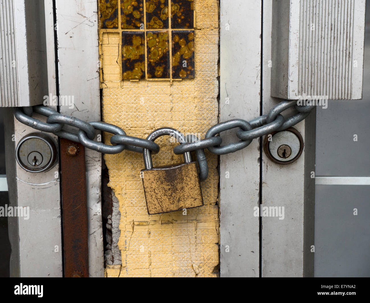 Lock and chain on a commercial buildings metal doors Stock Photo