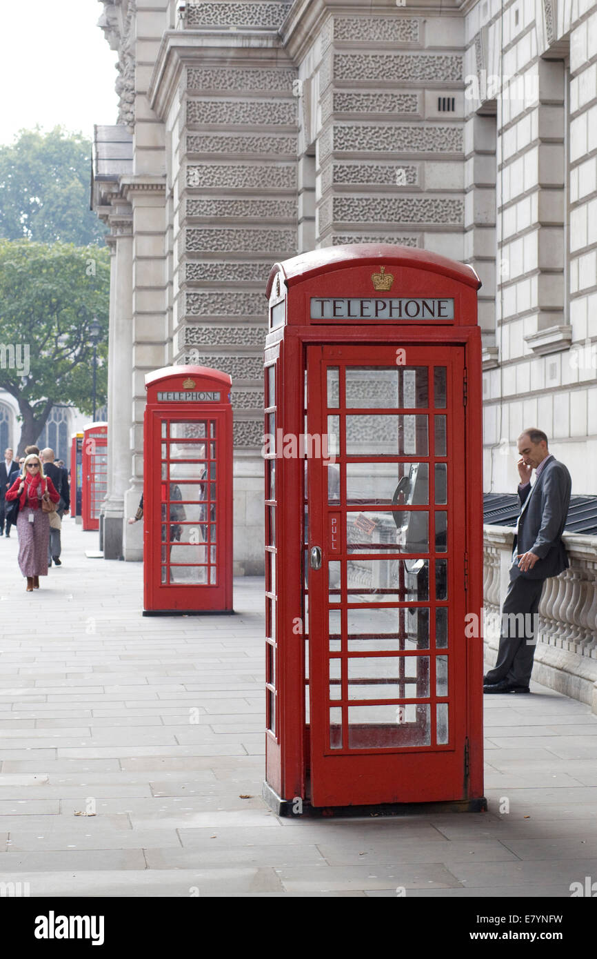 Three Red Telephone Box on the streets of London England Stock Photo