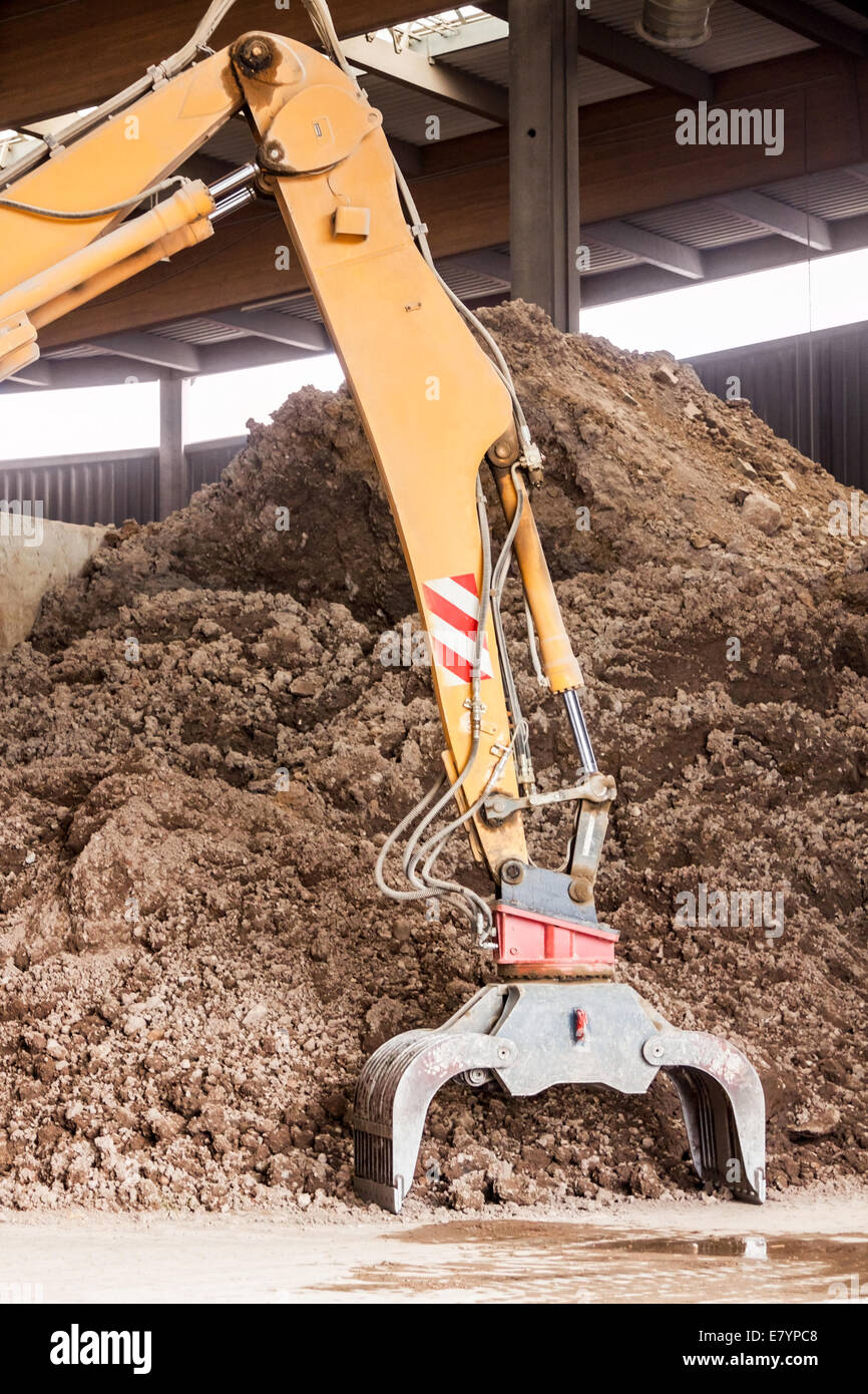 Heavy duty excavator doing earth moving parked undercover in an open