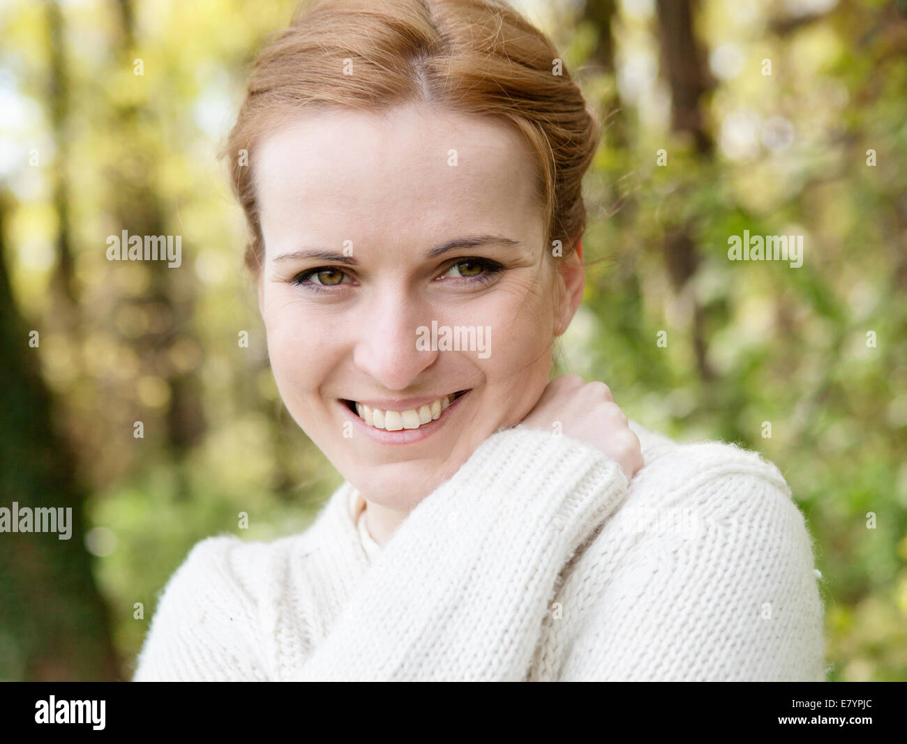 Portrait of a smiling woman in the park Stock Photo - Alamy