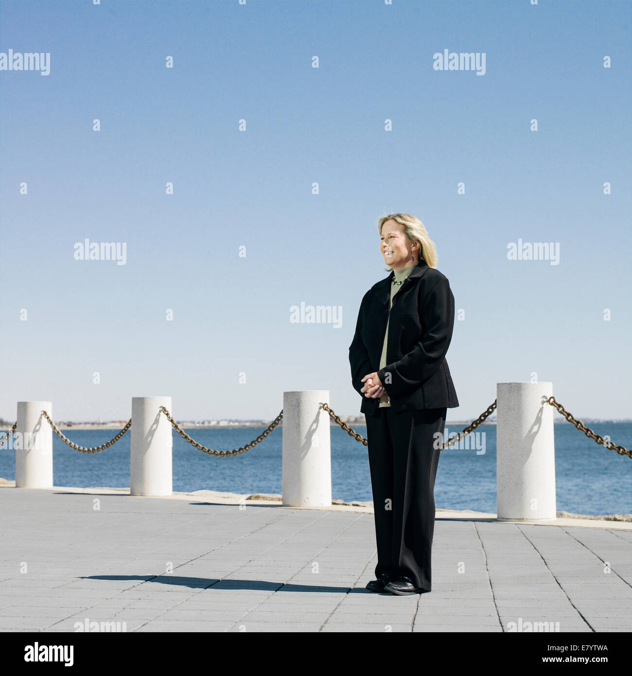 Middle-aged woman on seafront promenade Stock Photo