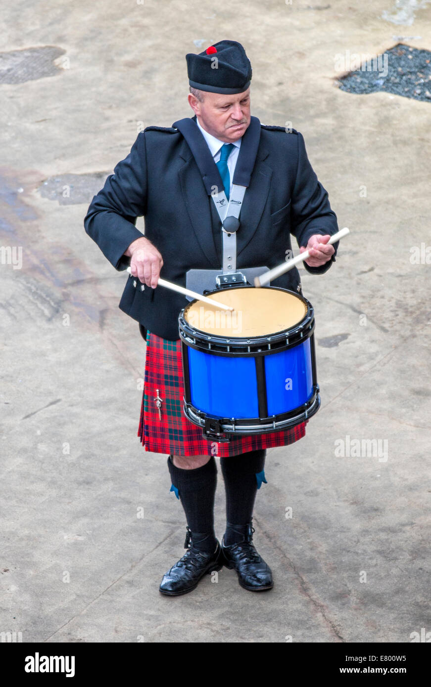 Scottish musician drummer from a band acts as host upon arrival of transatlantic ships in the port of Invergordon in Scotland co Stock Photo