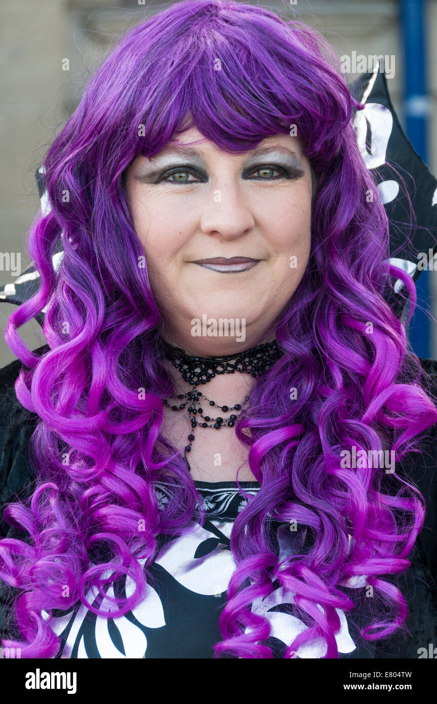 Portrait of cute smiling gothic girl on the roof at sunset time. Pastel goth  with violet (purple) hair in black clothes Stock Photo - Alamy