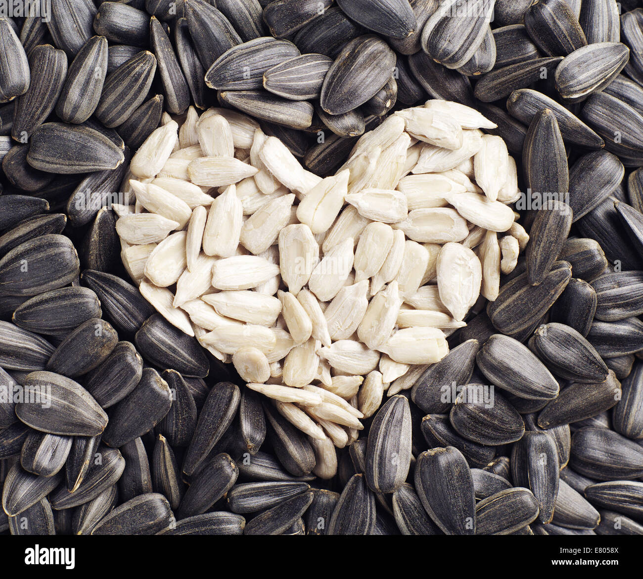 Background with sunflower seeds in the shape of hearts. Conceptual photo Stock Photo Alamy