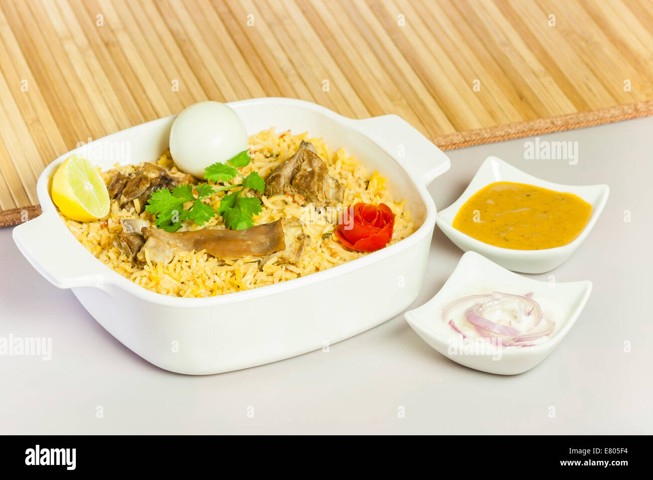 Full view of delicious mutton (lamb) biryani garnished with tomato peel