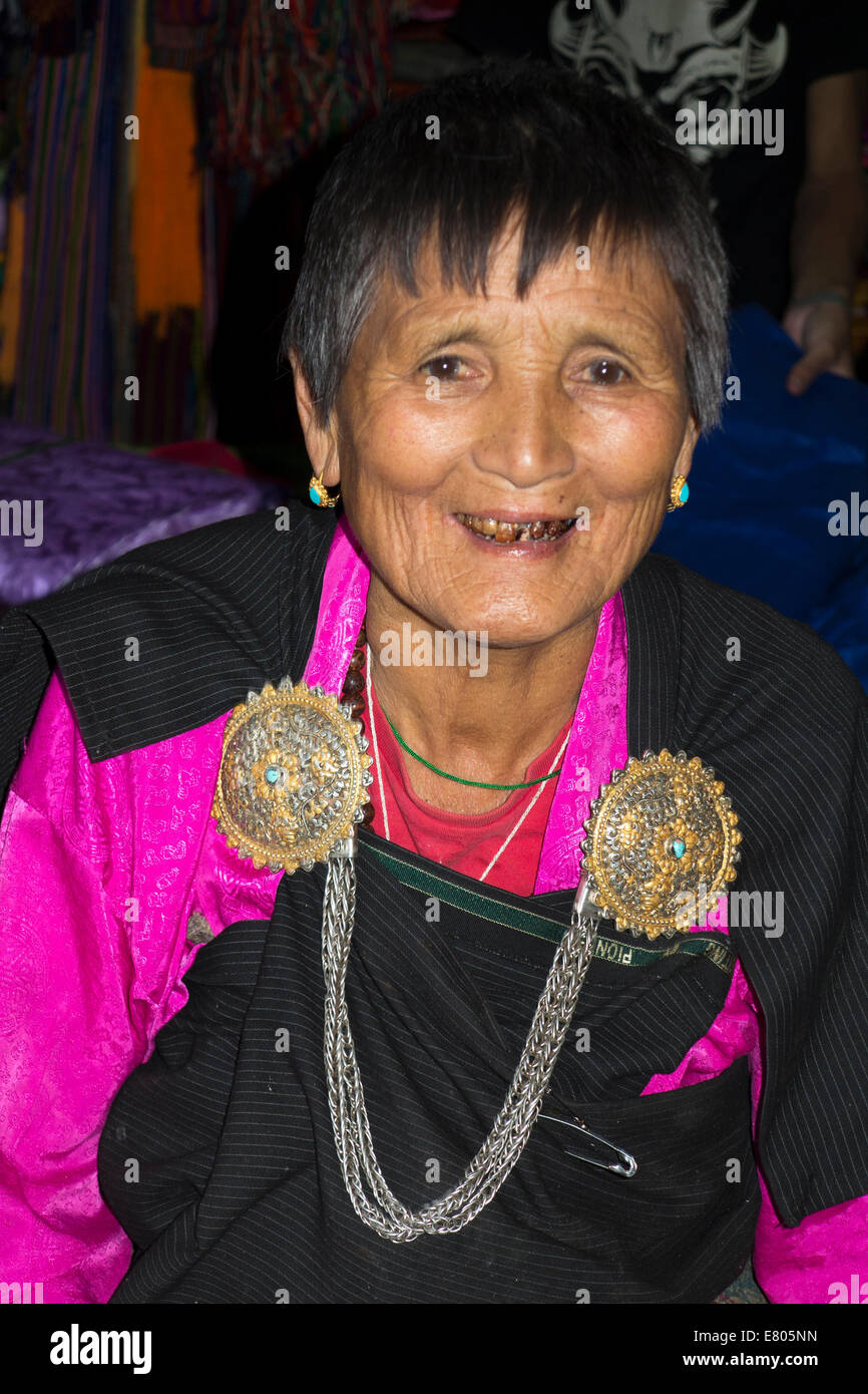 Bhutan, Paro, old Bhutanese woman wearing traditional kira costume with antique metal clasp Stock Photo