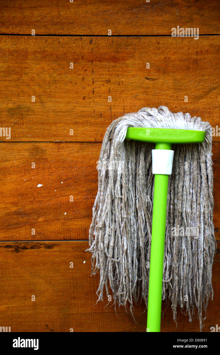 green mop floors on the brown wood wall Stock Photo Alamy