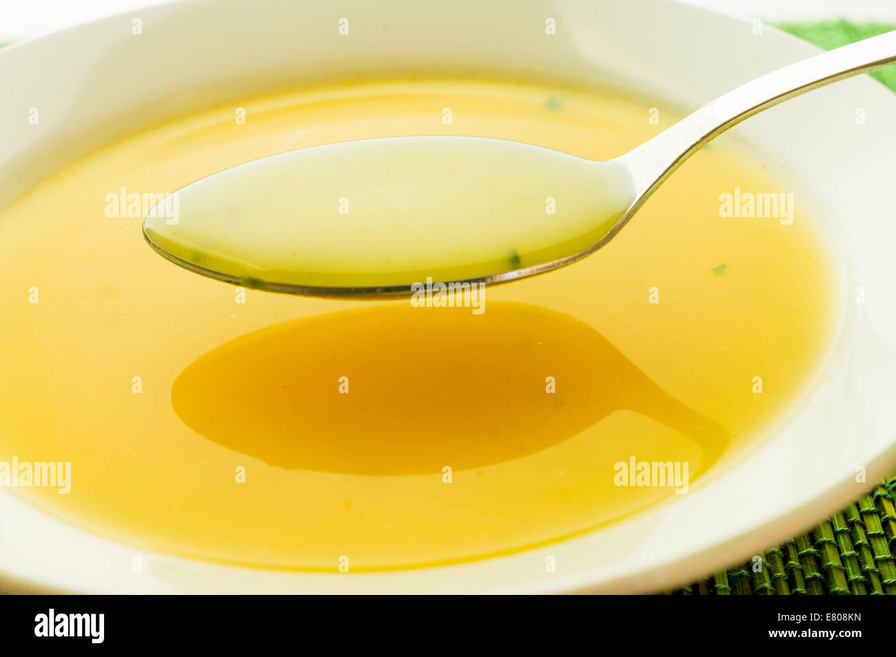 Cheese soup on a spoon in white plate Stock Photo