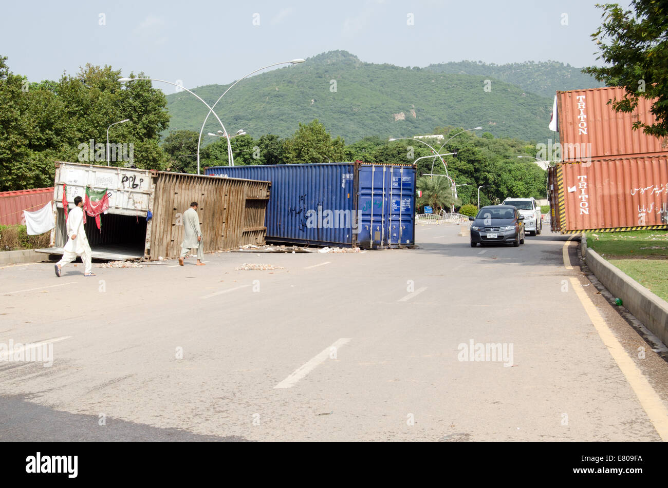 ISLAMABAD, PAKISTAN  SEPTEMBER 24, 2014:  A road block made by protesters with shipping containers and piles of stones. Stock Photo