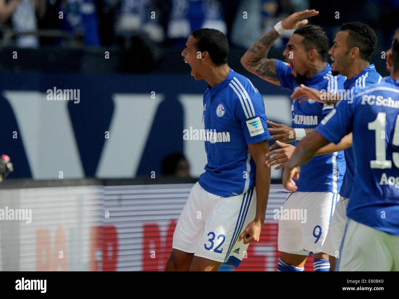 Gelsenkirchen, Germany. 27th Sep, 2014. Schalke's Joel Matip (L-R) celebrates his 1-0 goal with Kevin-Prince Boateng and Maxim Choupo-Moting during the German Bundesliga soccer match between FC Schalke 04 and Borussia Dortmund at Veltins Arena in Gelsenkirchen, Germany, 27 September 2014. Photo: Jonas Guettler/dpa (ATTENTION: The DFL limits the utilisation and publication of sequential pictures on the internet and other online media during the match on 15 pictures per game.)/dpa/Alamy Live News Stock Photo