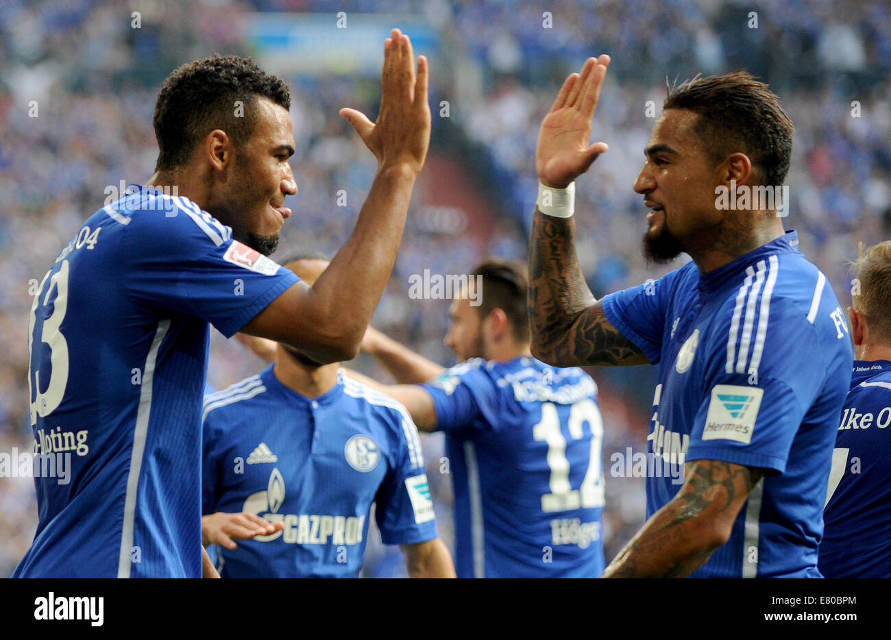 Gelsenkirchen, Germany. 27th Sep, 2014. Schalke's Eric Maxim Choupo-Motinglies (L) celebrates his 2-0 goal with team-mate Kevin-Prince Boateng (R) during the German Bundesliga soccer match between FC Schalke 04 and Borussia Dortmund at Veltins Arena in Gelsenkirchen, Germany, 27 September 2014. Photo: Jonas Guettler/dpa (ATTENTION: The DFL limits the utilisation and publication of sequential pictures on the internet and other online media during the match on 15 pictures per game.)/dpa/Alamy Live News Stock Photo