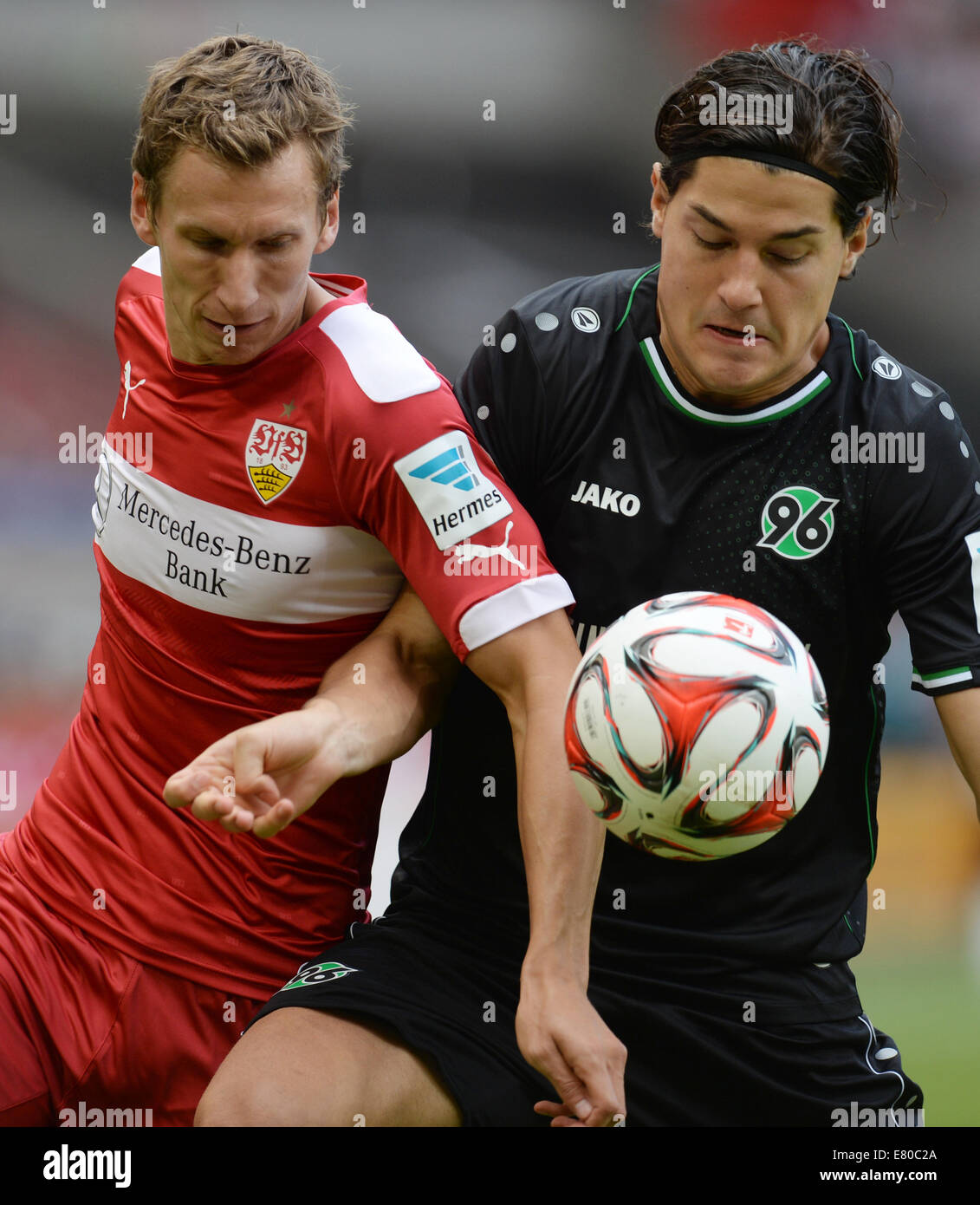 Stuttgart, Germany. 27th Sep, 2014. Stuttgart's Florian Keil (L) vies for the ball with Miiko Albornoz (R) during the German Bundesliga soccer match between VfB Stuttgart and Hannover 96 at Mercedes-Benz Arena in Stuttgart, Germany, 27 September 2014. Photo: Bernd Weissbrod/dpa (ATTENTION: The DFL limits the utilisation and publication of sequential pictures on the internet and other online media during the match (including half-time) on 15 pictures per game.)/dpa/Alamy Live News Stock Photo