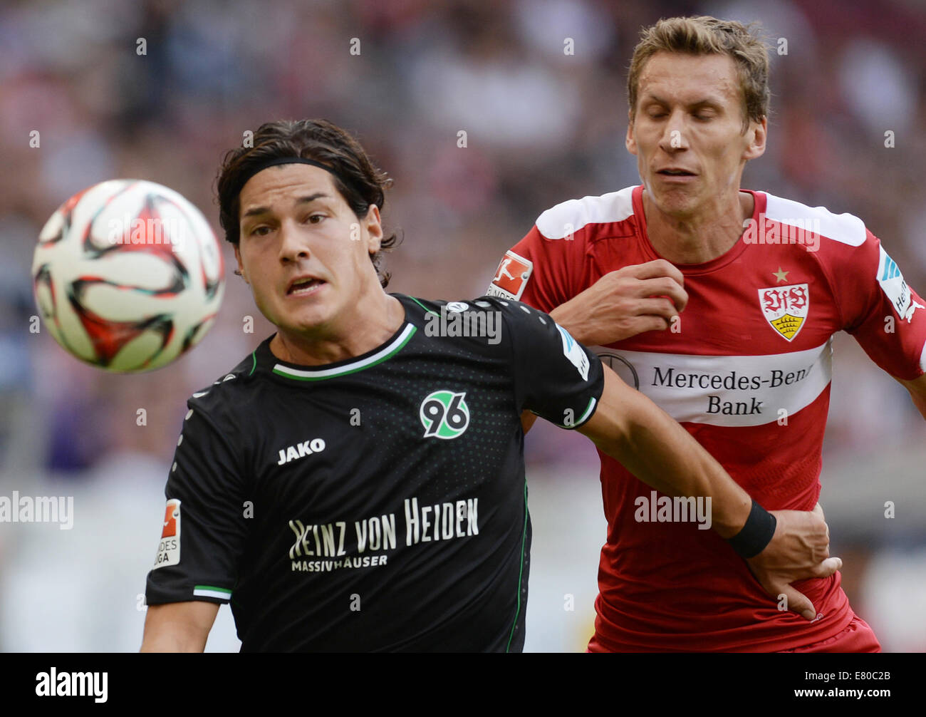 Stuttgart, Germany. 27th Sep, 2014. Stuttgart's Florian Keil (R) vies for the ball with Miiko Albornoz (L) during the German Bundesliga soccer match between VfB Stuttgart and Hannover 96 at Mercedes-Benz Arena in Stuttgart, Germany, 27 September 2014. Photo: Bernd Weissbrod/dpa (ATTENTION: The DFL limits the utilisation and publication of sequential pictures on the internet and other online media during the match (including half-time) on 15 pictures per game.)/dpa/Alamy Live News Stock Photo