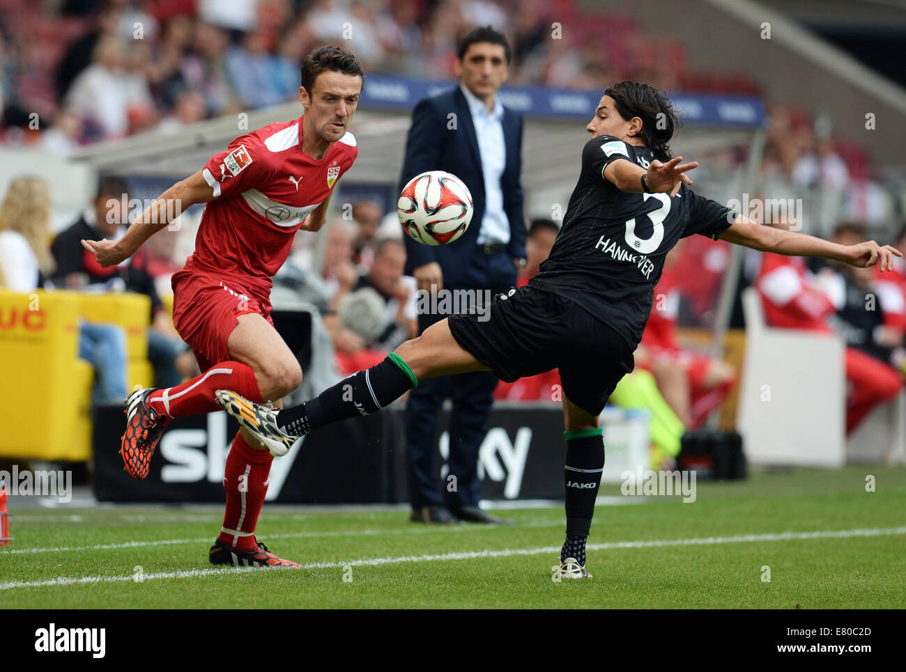 Stuttgart, Germany. 27th Sep, 2014. Stuttgart's Christian Gentner (L) vies for the ball with Hanover's Miiko Albornoz (R) during the German Bundesliga soccer match between VfB Stuttgart and Hannover 96 at Mercedes-Benz Arena in Stuttgart, Germany, 27 September 2014. Photo: Bernd Weissbrod/dpa (ATTENTION: The DFL limits the utilisation and publication of sequential pictures on the internet and other online media during the match (including half-time) on 15 pictures per game.)/dpa/Alamy Live News Stock Photo