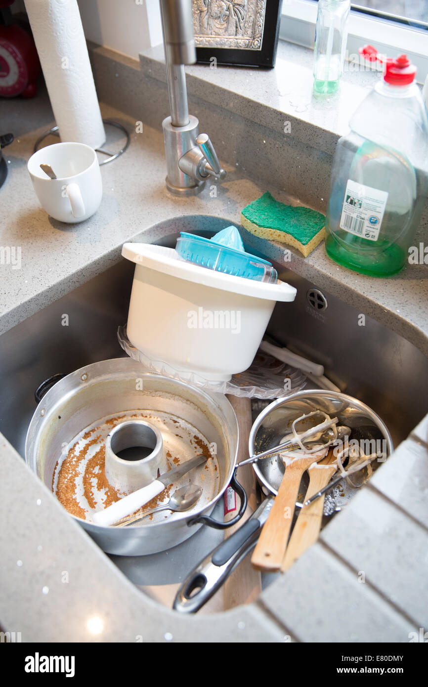 washing up in kitchen sink after baking cakes Stock Photo