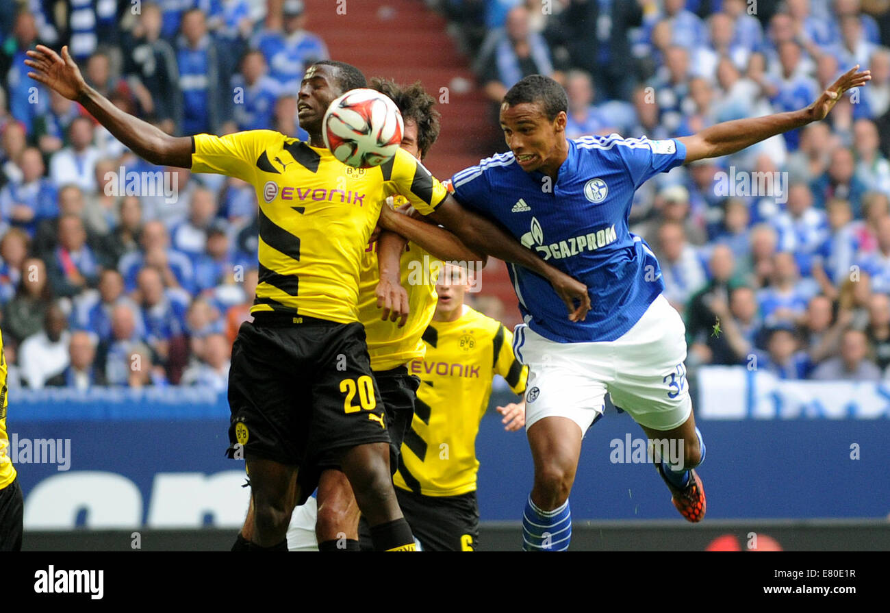 Gelsenkirchen, Germany. 27th Sep, 2014. Dortmund's Adrian Ramos (L) and Schalke's Joel Matip (R) vie for the ball during the German Bundesliga soccer match between FC Schalke 04 and Borussia Dortmund at Veltins Arena in Gelsenkirchen, Germany, 27 September 2014. Photo: Jonas Guettler/dpa (ATTENTION: The DFL limits the utilisation and publication of sequential pictures on the internet and other online media during the match on 15 pictures per game.)/dpa/Alamy Live News Stock Photo