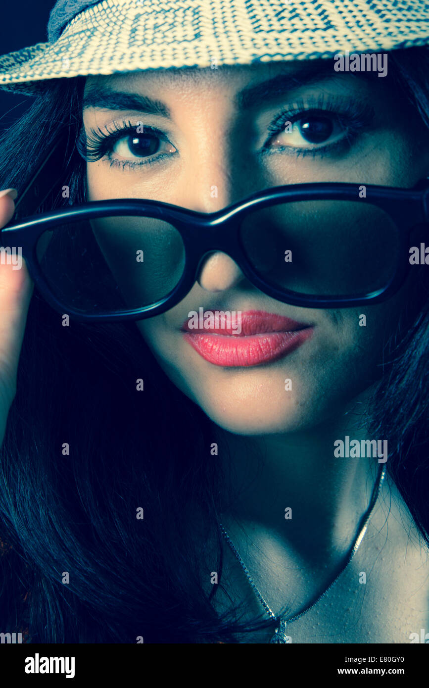 Woman wearing sunglasses and pouting her lips Stock Photo