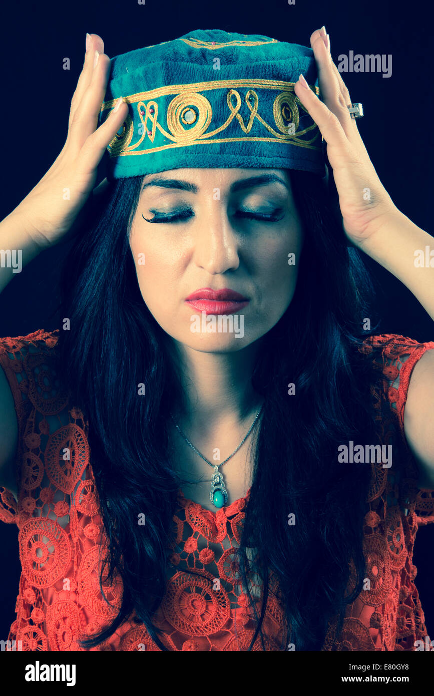 Woman wearing traditional middle eastern hat Stock Photo