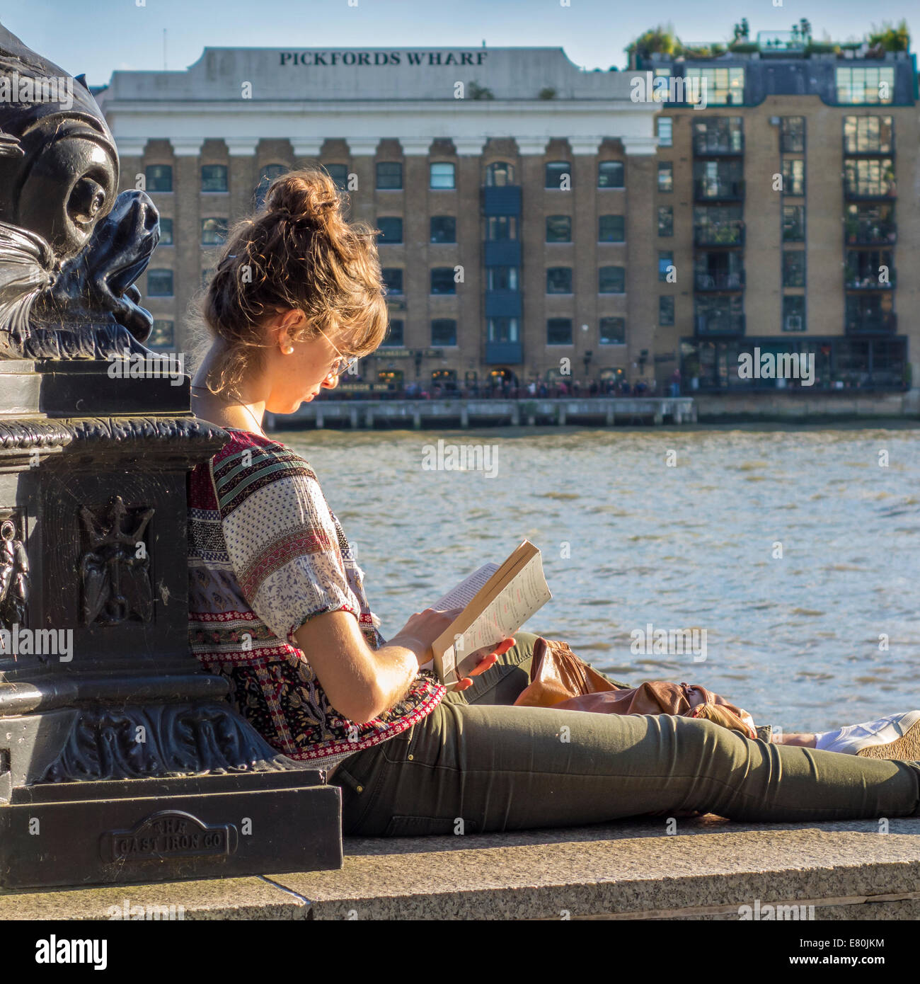 Young Woman Girl Reading Studying River Thames London Stock Photo