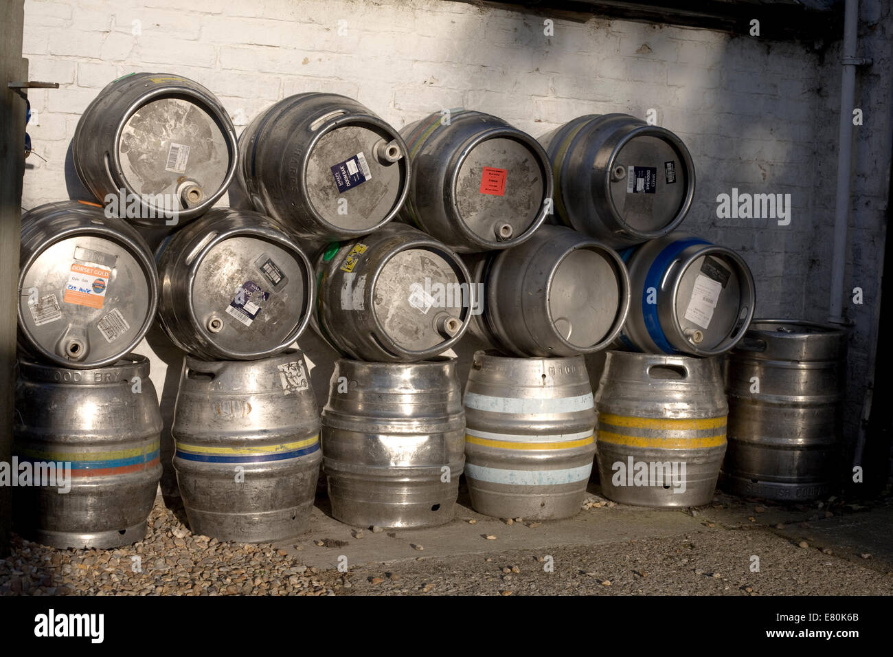 Pile of metal beer barrels outside the Old house at home in Chidham