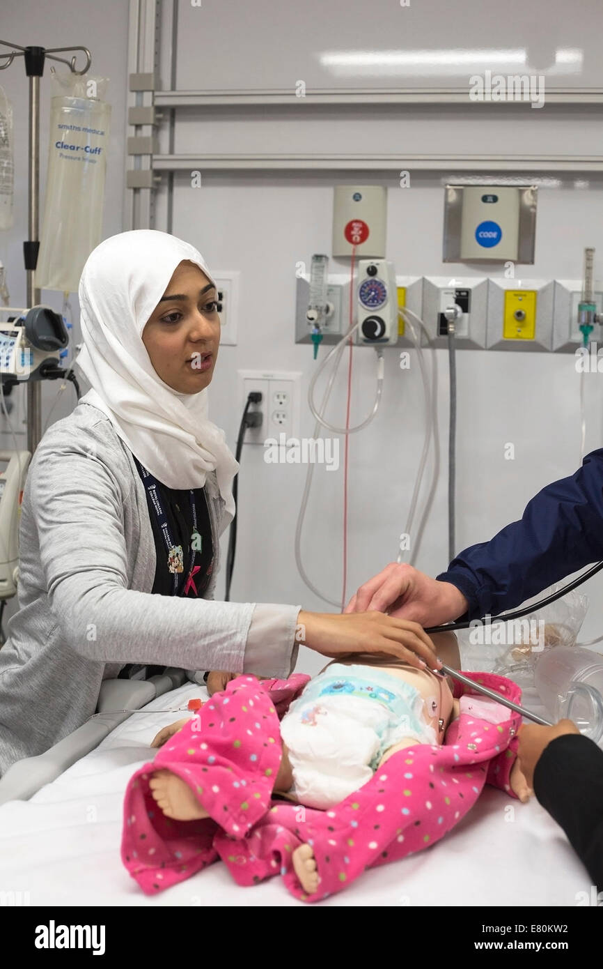 Calgary, Alberta, Canada, 27 Sep, 2014. Doors Open YYC allows the public to participate in a hands-on demonstration of a simulated medical emergency using a computerized pediatric mannequin in the new KidSIM Centre at the Alberta Children's Hospital with Dr. Amani Azizalrahman.  The state-of-the-art facility, the largest pediatric simulation centre in Canada, provides practitioners and families of patients with a simulated clinical experience as close as possible to real-life situations. Stock Photo