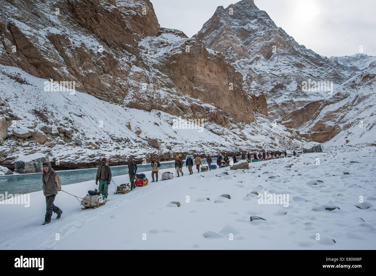 Porters are pulling trekkers luggage on Zanskar River during Chadar trek Stock Photo