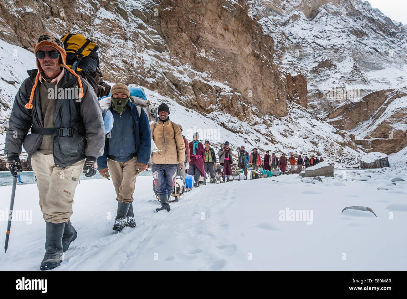 Porters are pulling trekkers luggage on Zanskar River during Chadar trek Stock Photo