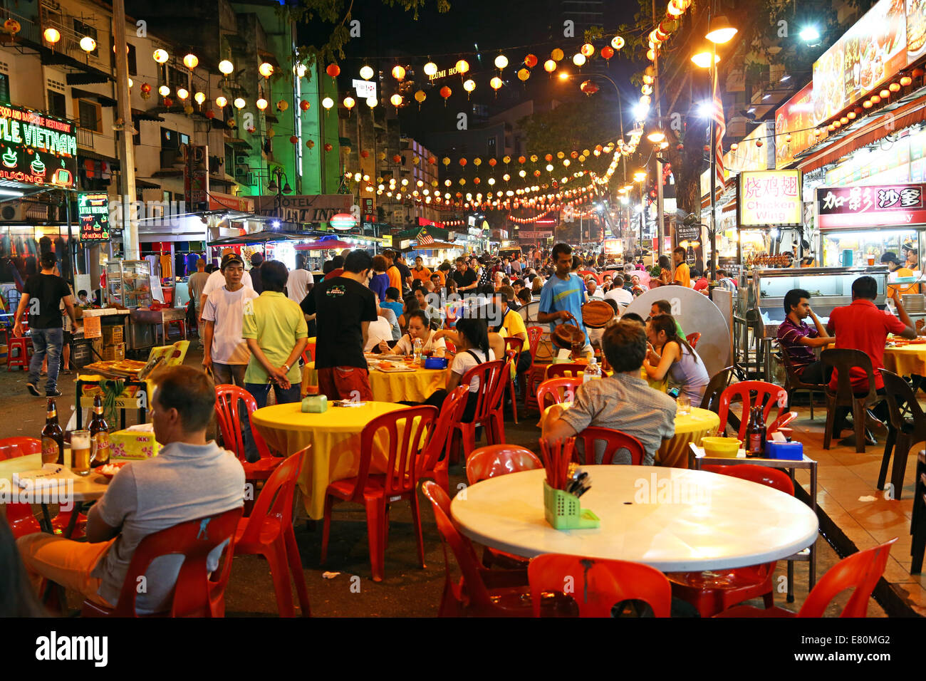 People eating at outdoor restaurants and street food in Jalan Alor in Bukit Bintang in Kuala Lumpur, Malaysia Stock Photo