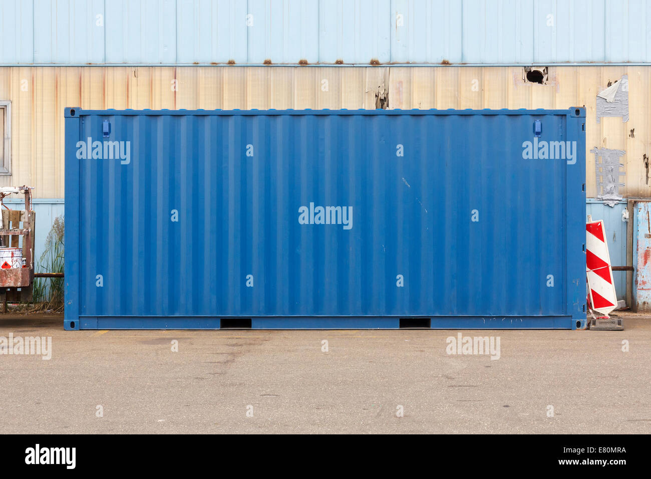Blue shipping container at a commercial port facility. Stock Photo