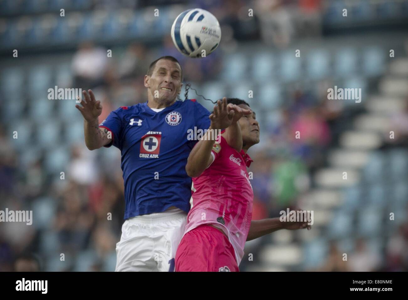Mexico City, Mexico. 27th Sep, 2014. Christian Gimenez (L) of Cruz Azul vies for the ball with Carlos Pena of Leon during a match of the MX League Opening Tournament, at Azul Stadium, in Mexico City, capital of Mexico, on Sept. 27, 2014. Credit:  Alejandro Ayala/Xinhua/Alamy Live News Stock Photo