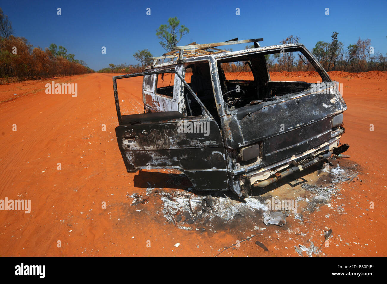Burnt-out wreck of vehicle in middle of road to Cape Leveque, Dampier Peninsula, Kimberley region, Western Australia. No PR Stock Photo