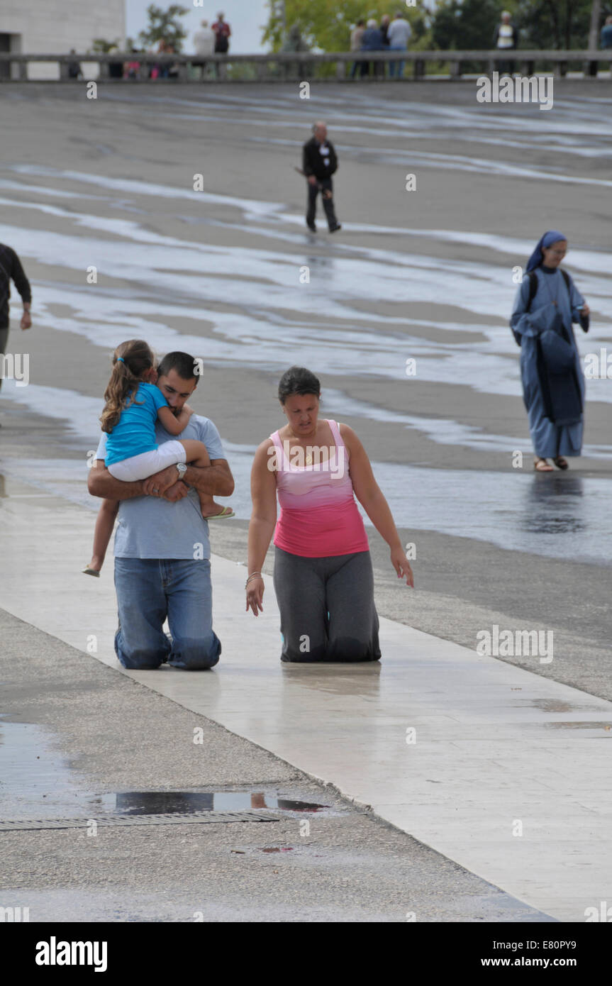 Pilgrims approaching cathedral on their knees at Fatima, Portugal Stock  Photo - Alamy