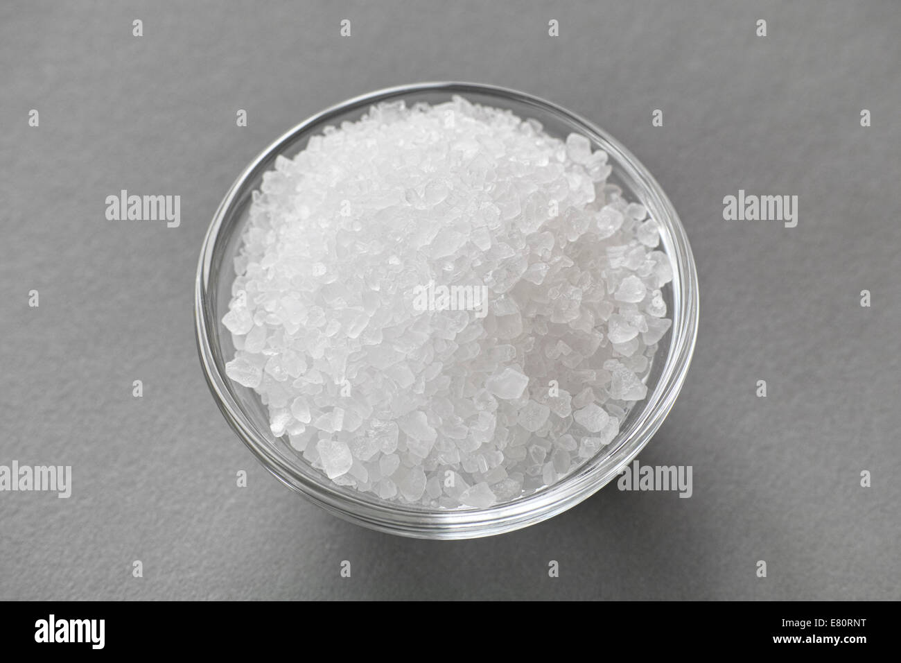 Sea salt in a glass bowl. Close-up. Stock Photo