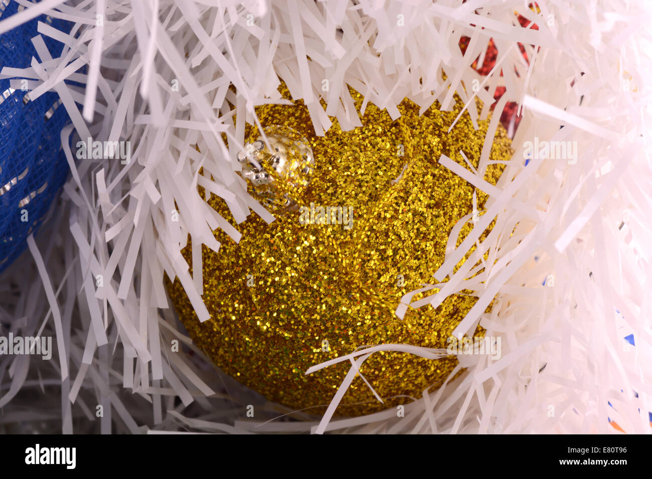 Golden christmas ball on shining glitter background close-up Stock Photo