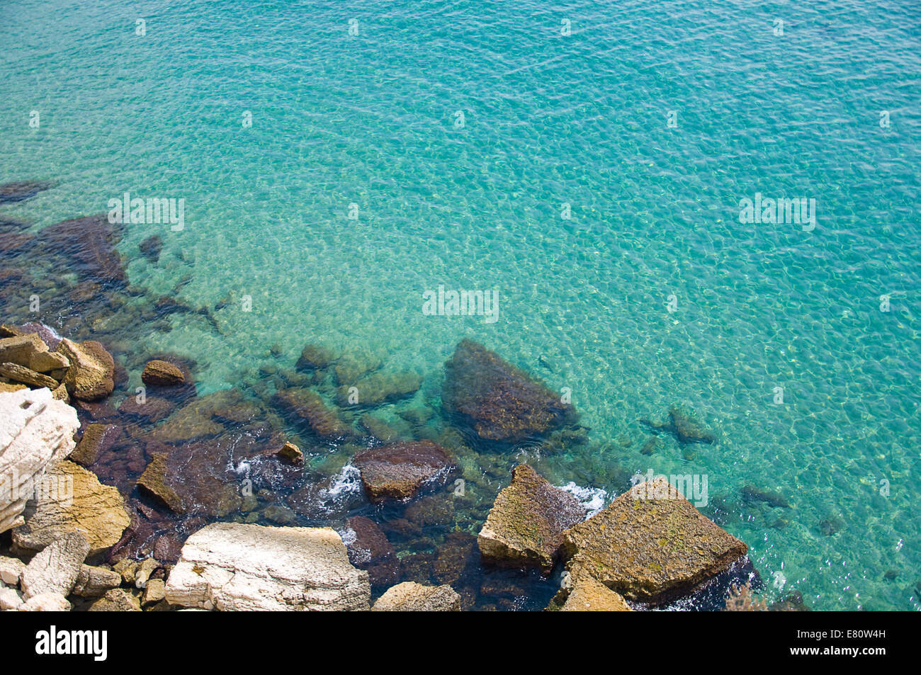 Rocks at the bottom of a cliff in the Mediterranean sea Stock Photo