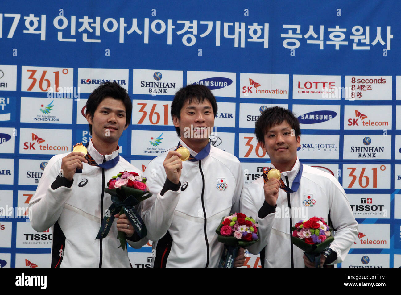 Incheon, South Korea. 28th Sep, 2014. Gold medalists Wada Shogo (L), Sasaki Tomoyuki (C) and Asato Shusaku of Japan pose during the awarding ceremony of the men's trios 2nd block contest of bowling at the 17th Asian Games in Incheon, South Korea, Sept. 28, 2014. Japan claimed the title with 3,881 points. Credit:  Jin Linpeng/Xinhua/Alamy Live News Stock Photo