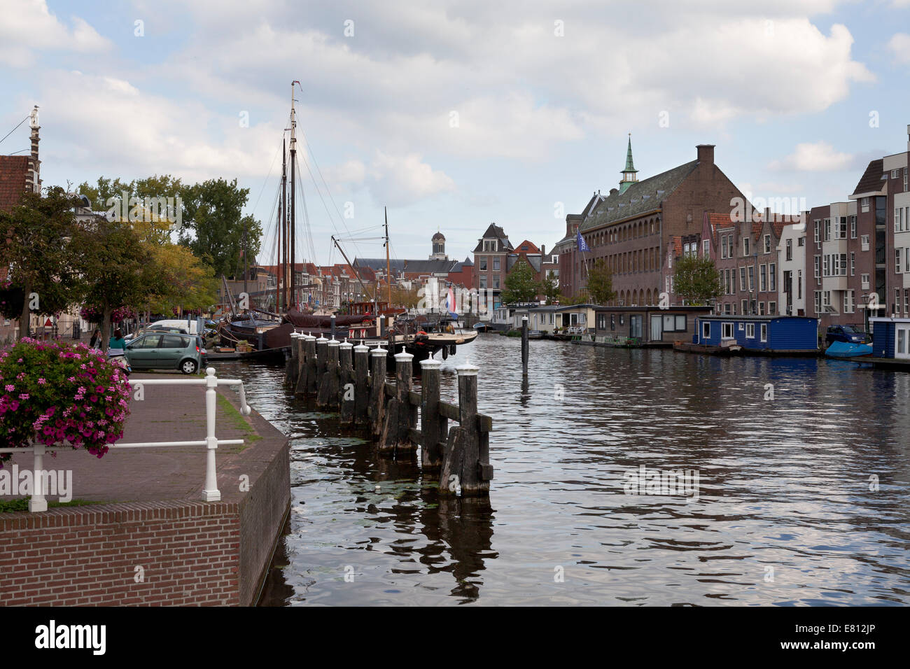 Ships in the historical harbour in the city of Leiden, with in the background windmill de Put Stock Photo