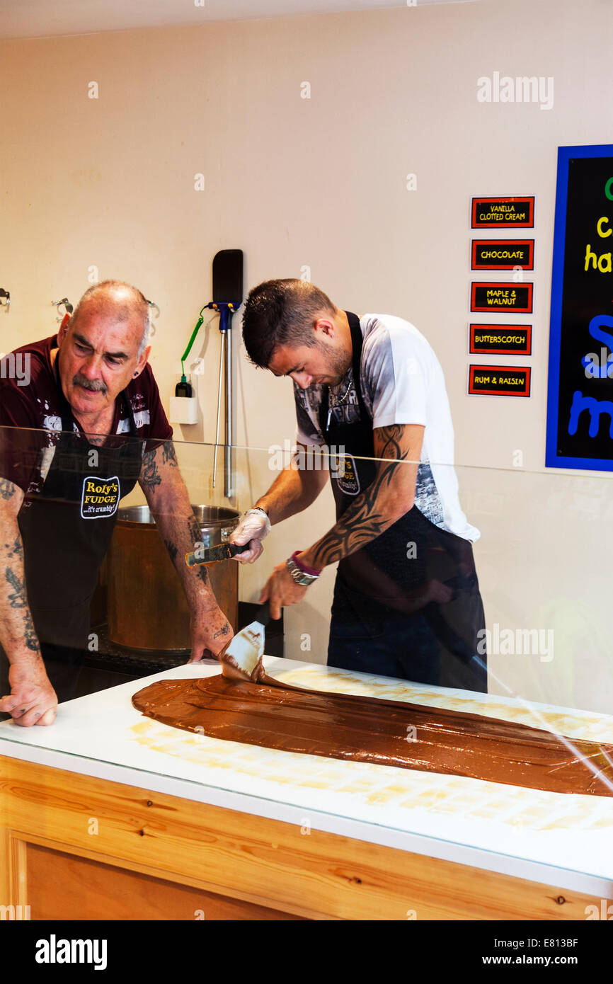 fudge makers making sweets spreading out toffee product while soft Cornwall Cornish west country
