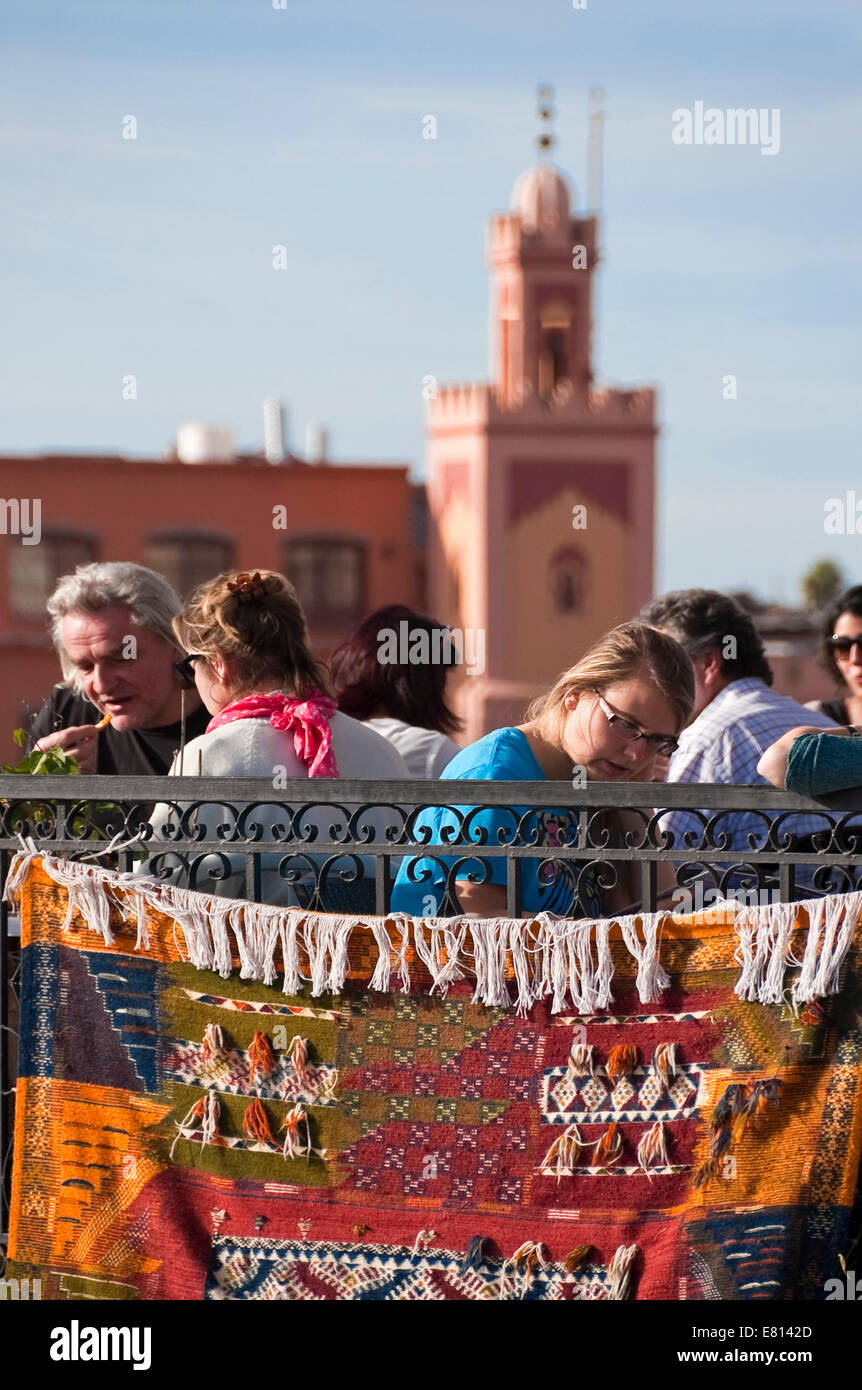 Vertical view of people at a rooftop cafe enjoying the views across Place Jemaa el-Fnaa in Marrakech. Stock Photo