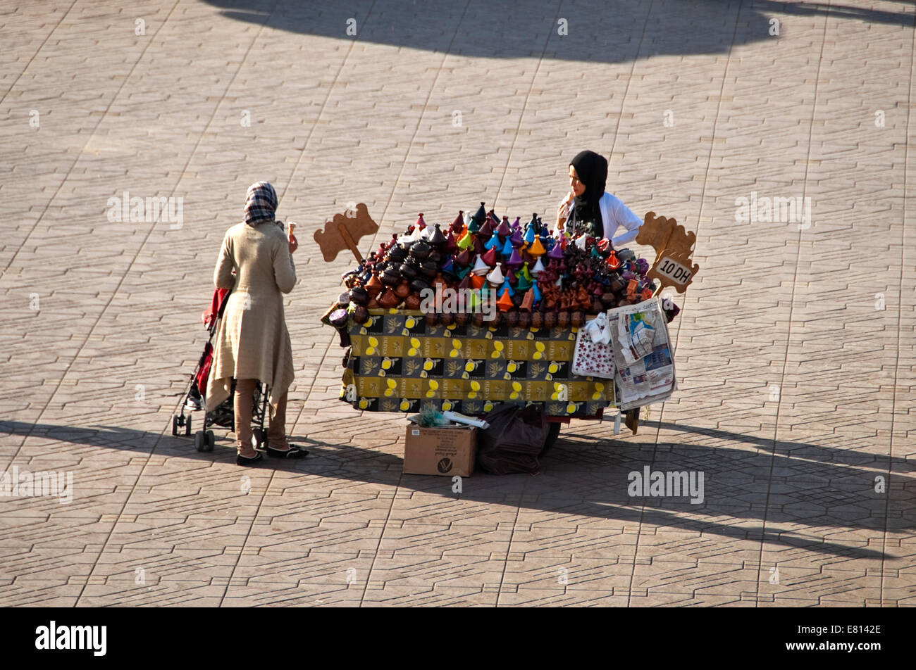 Horizontal aerial view of a stallholder and a customer chatting in Place Jemaa el-Fnaa in Marrakech. Stock Photo