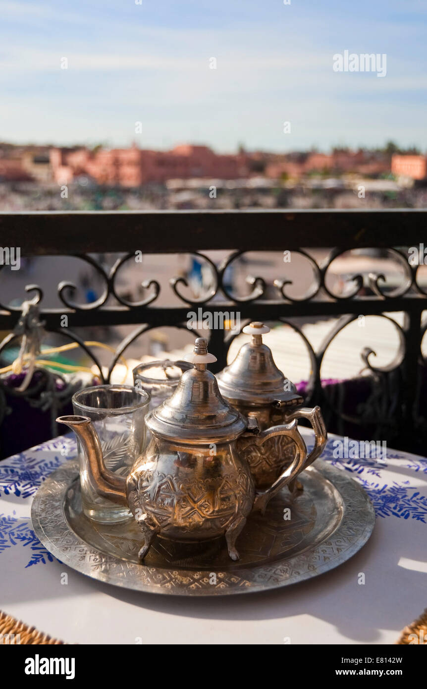 Vertical view of traditional mint tea on a table overlooking Place Jemaa el-Fnaa in Marrakech. Stock Photo