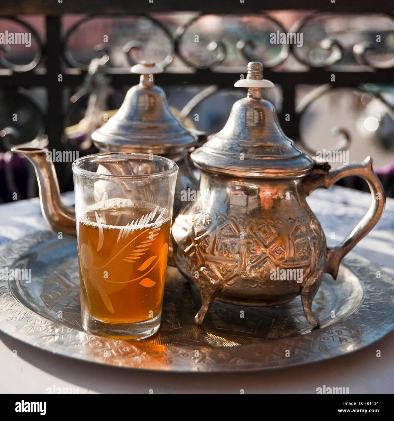Square close up of traditional mint tea served overlooking Place Jemaa el-Fnaa in Marrakech. Stock Photo